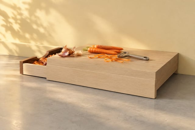 Cutting board with a slide-out scrap tray